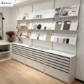 Modern wall-mounted powder-coated metal display rack with slanted storage drawers, ideal for tile and stone showrooms